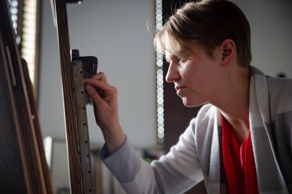 Painting Conservator Sara Boesen works to restore a painting at her studio in Des Moines, Friday, July 8, 2022.