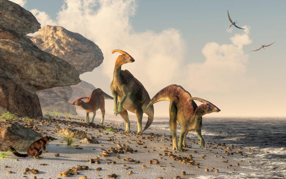 A 3D rendering of dinosaurs on a beach