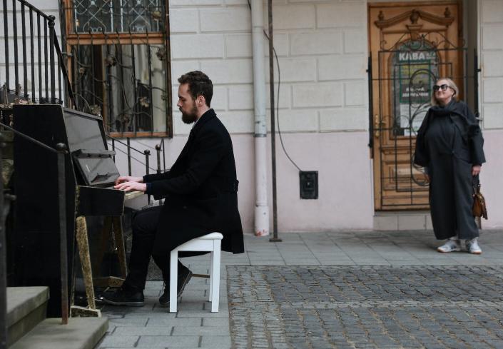 Alexander, who did not want to provide his last name, plays a piano placed outside in the Old Town on March 29, 2022, in Lviv, Ukraine. Alexander said he was playing because he missed being able to play the piano after having to leave his behind when he fled his hometown of Kramatorsk. <a href="https://www.gettyimages.com/detail/news-photo/alexander-plays-a-piano-placed-outside-in-the-old-town-on-news-photo/1388364859" rel="nofollow noopener" target="_blank" data-ylk="slk:Joe Raedle/Getty Images" class="link ">Joe Raedle/Getty Images</a>