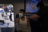 FILE - In this April 29, 2021, file photo, Nurse Natasha Garcia administers a dose of the Moderna COVID-19 vaccine to Samuel Sanchez in a mobile clinic set up in the parking lot of a shopping center in Orange, Calif. States across the country are dramatically scaling back their COVID-19 vaccine orders as interest in the shots wanes, putting the goal of herd immunity further out of reach. (AP Photo/Jae C. Hong, File)