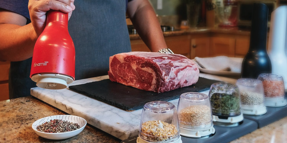 Home cook using FinaMill spice geinder next to a large beef roast.