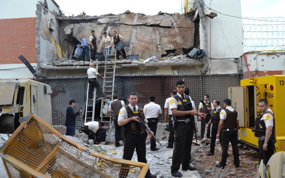 Guards and police inspect the vault blown up on Monday morning in Ciudad del Este, Paraguay - AP