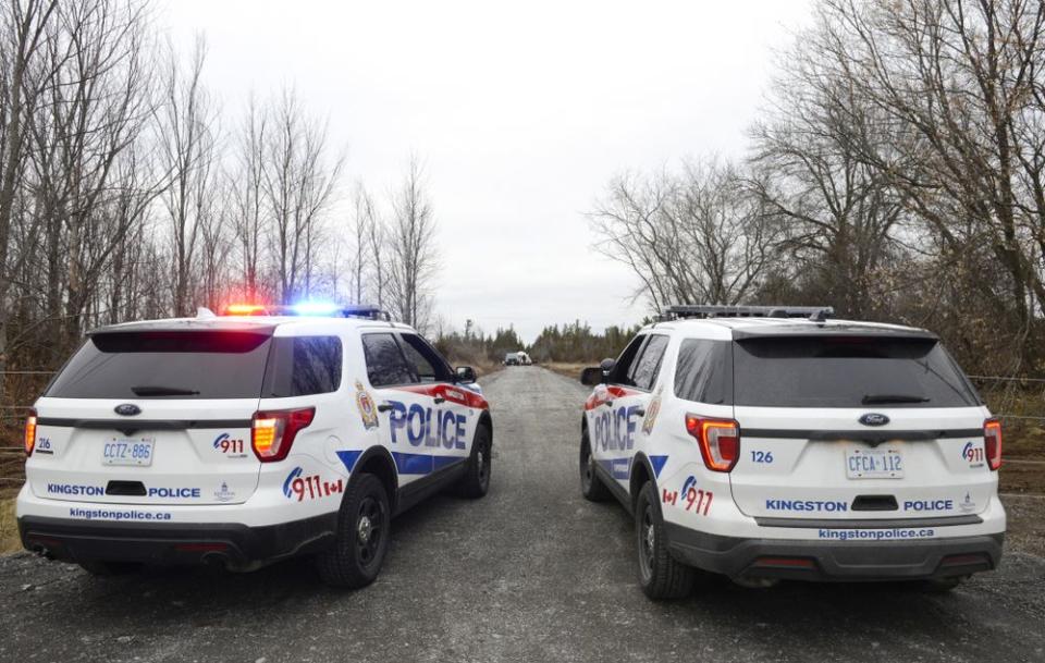 Two Kingston Police cars block a road leading to the site of a fatal plane crash in Kingston, Ontario, in Canada. | Sean Kilpatrick/The Canadian Press via AP