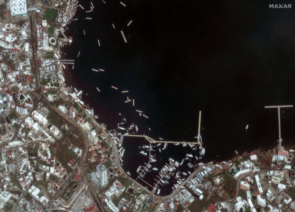 Satellite image shows damaged boats in a marina, in Acapulco Bay (EPA)