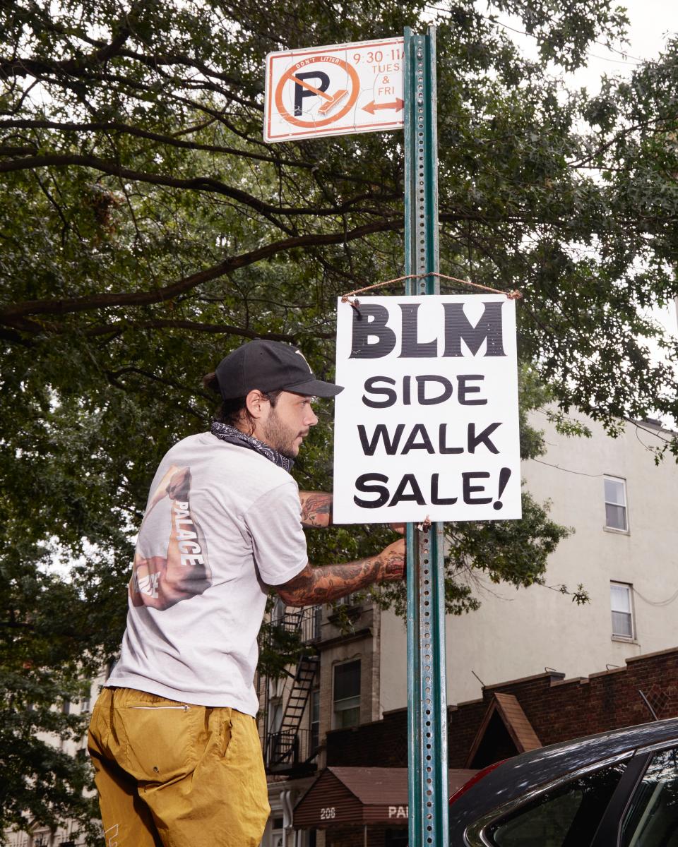 Brandon Danciu hangs a sign.