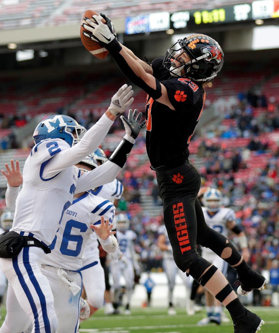 Stratford's Gavin Leonhardt (23) catches a pass in the end zone for a touchdown against Mondovi's Jake Linse (2) during the WIAA Division 6 state championship game Thursday at Camp Randall Stadium in Madison.