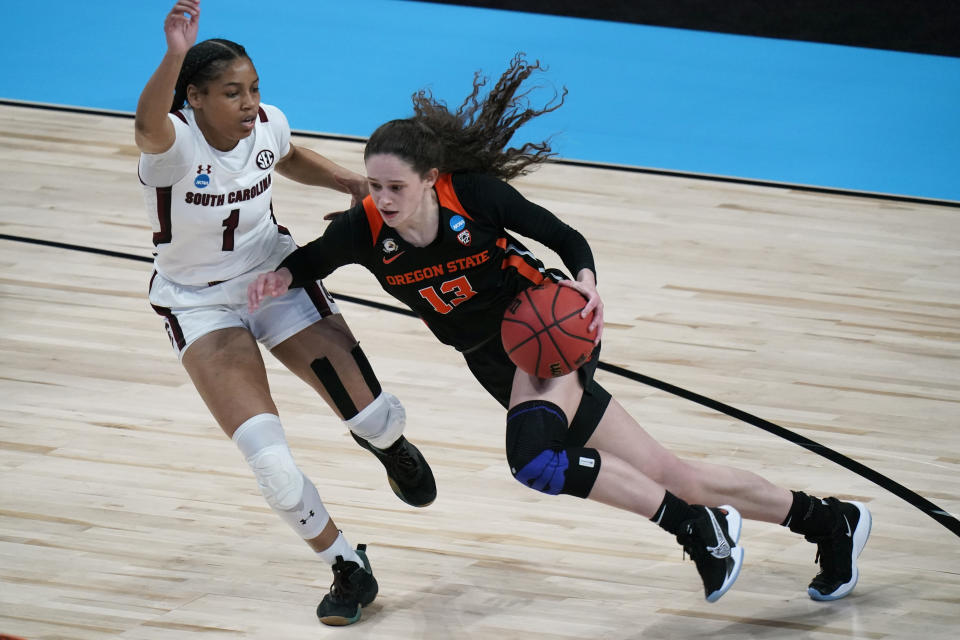 Oregon State guard Sasha Goforth (13) drives past South Carolina guard Zia Cooke (1) during the first half of a college basketball game in the second round of the women's NCAA tournament at the Alamodome in San Antonio, Tuesday, March 23, 2021. (AP Photo/Eric Gay)