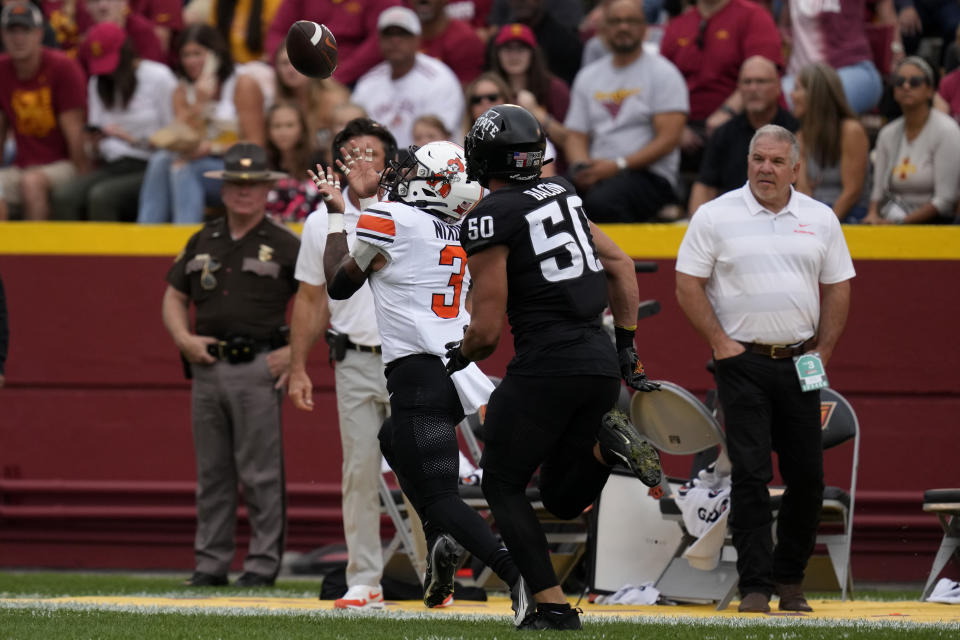 Oklahoma State running back Jaden Nixon (3) catches a 60-yard touchdown pass in front of Iowa State linebacker Caleb Bacon (50) during the first half of an NCAA college football game, Saturday, Sept. 23, 2023, in Ames, Iowa. (AP Photo/Charlie Neibergall)