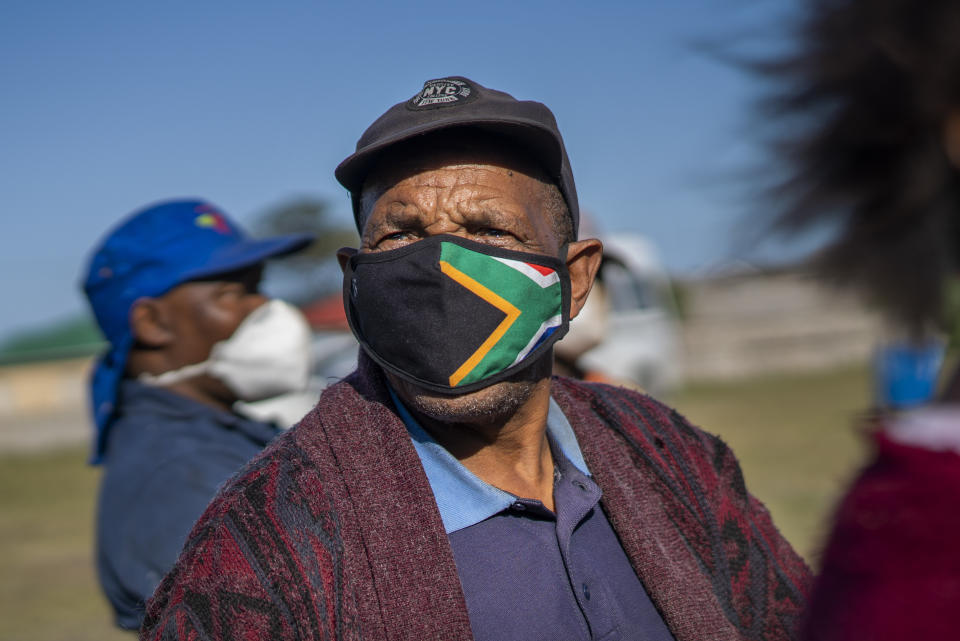 A man waits at the Swartkops railroad yard to receive a COVID-19 vaccination outside Gqeberha, South Africa, Wednesday Sept. 22, 2021. South Africa has sent a train carrying COVID-19 vaccines into one of its poorest provinces to get doses to areas where healthcare facilities are stretched. The vaccine train, named Transvaco, will go on a three-month tour through the Eastern Cape province and stop at seven stations for two weeks at a time to vaccinate people. (AP Photo/Jerome Delay)