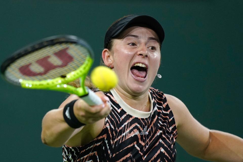 CORRECTS TO JELENA OSTAPENKO, INSTEAD OF ONS JABEUR - Jelena Ostapenko, of Latvia, returns a shot to Victoria Azarenka, of Belarus, at the BNP Paribas Open tennis tournament Friday, Oct. 15, 2021, in Indian Wells, Calif. (AP Photo/Mark J. Terrill)