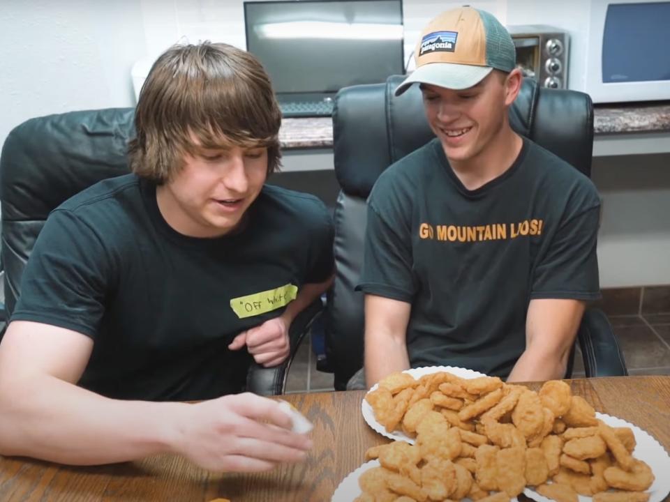 A picture of Matthew Beem and a friend in front of a pile of chicken nuggets