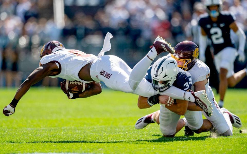 Penn State linebacker Dominic DeLuca trips up Central Michigan’s ball carrier Jalen McGaughy during the game on Saturday, Sept. 24, 2022.