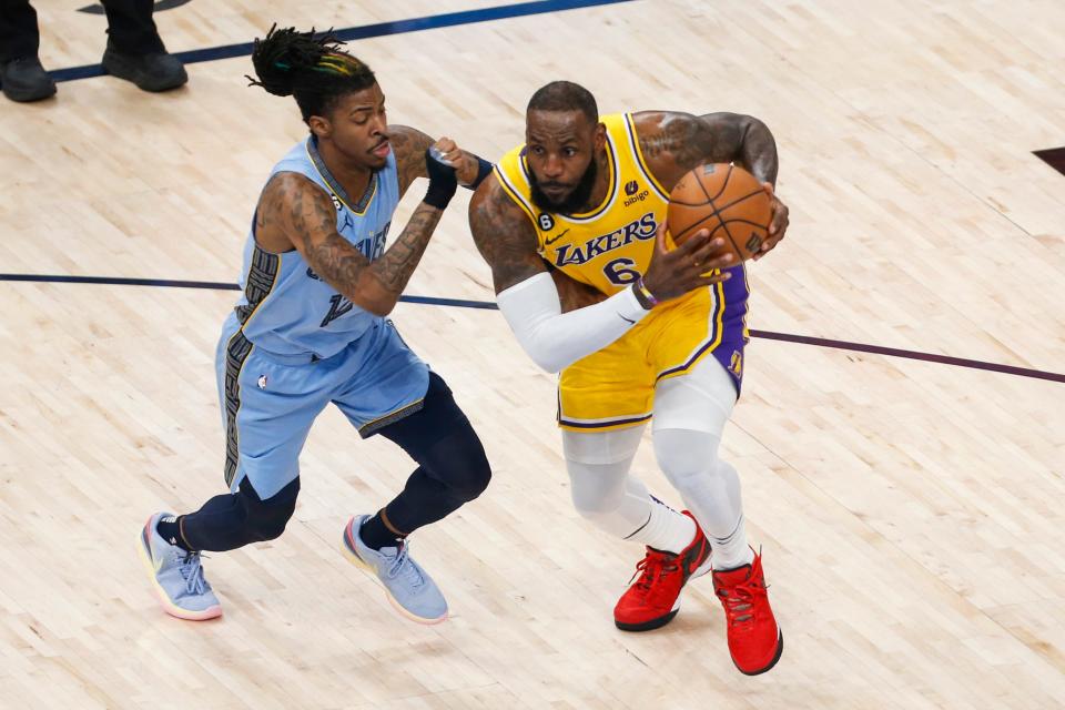 Grizzlies'  Ja Morant (12) guards Lakers'  LeBron James (6) drives to the basket during Game 5 between the Memphis Grizzlies and LA Lakers in their first round NBA playoffs series at FedExForum in Memphis, Tenn., on Wednesday, April 26, 2023. 