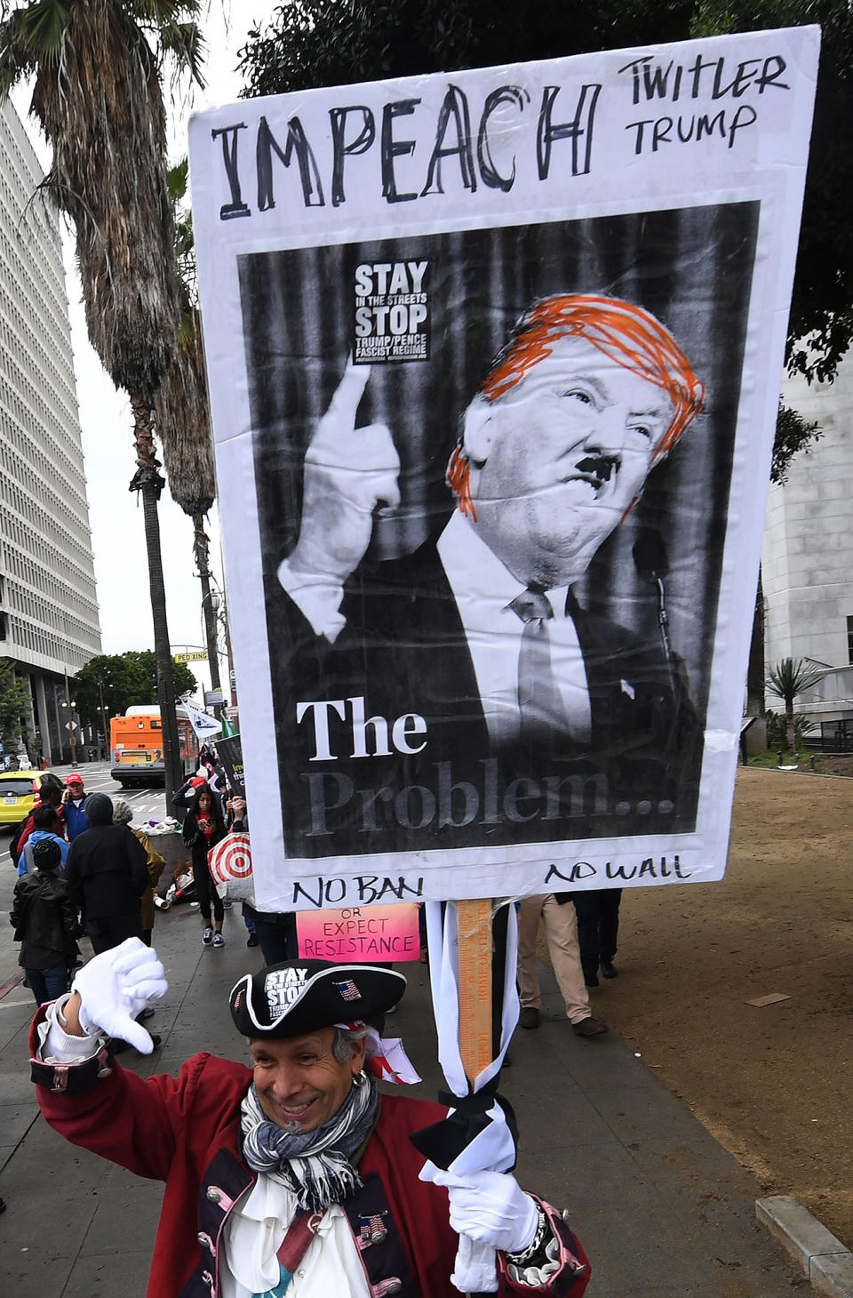 <p>Protesters carry anti-Trump signs during a ‘Not My President Day’ demonstration outside City Hall in Los Angeles on Feb. 20, 2017. (Mark Ralston/AFP/Getty Images) </p>