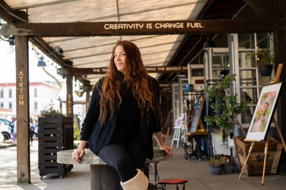 Shira Lane sits outside Atrium 916 earlier this month in Old Sacramento. Her gallery supports local artists. The gallery’s building would receive a major remodel under current proposals.