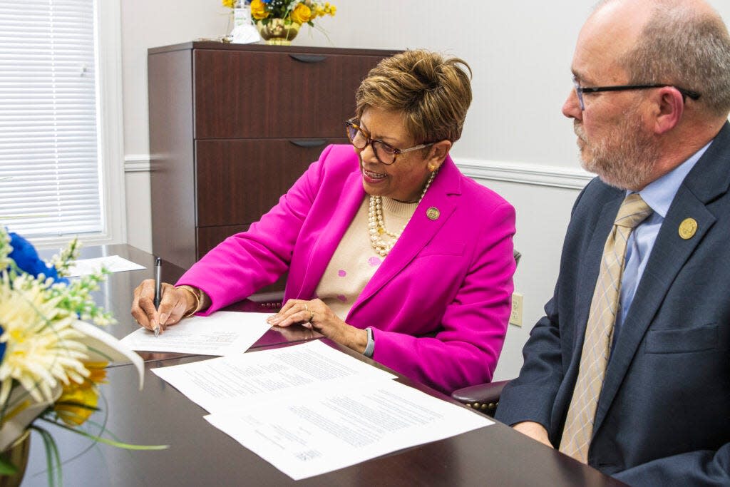 Cynthia Warrick, president of Stillman College, signs a memorandum of understanding with Southern Illinois University’s School of Law on Wednesday as Stillman College Provost Mark McCormick observes.
