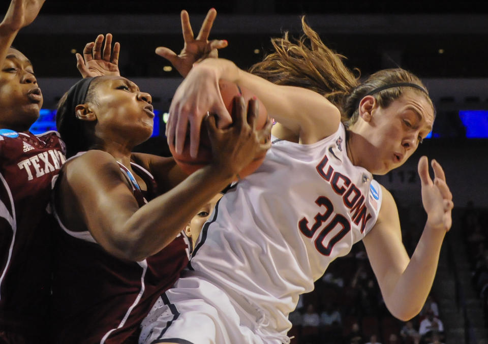 Texas A&M's Karla Gilbert (34) and Connecticut's Breanna Stewart (30) battle for a rebound during the first half of their regional final in the NCAA college basketball tournament in Lincoln, Neb., Monday March 31, 2014. (AP Photo/Dave Weaver)