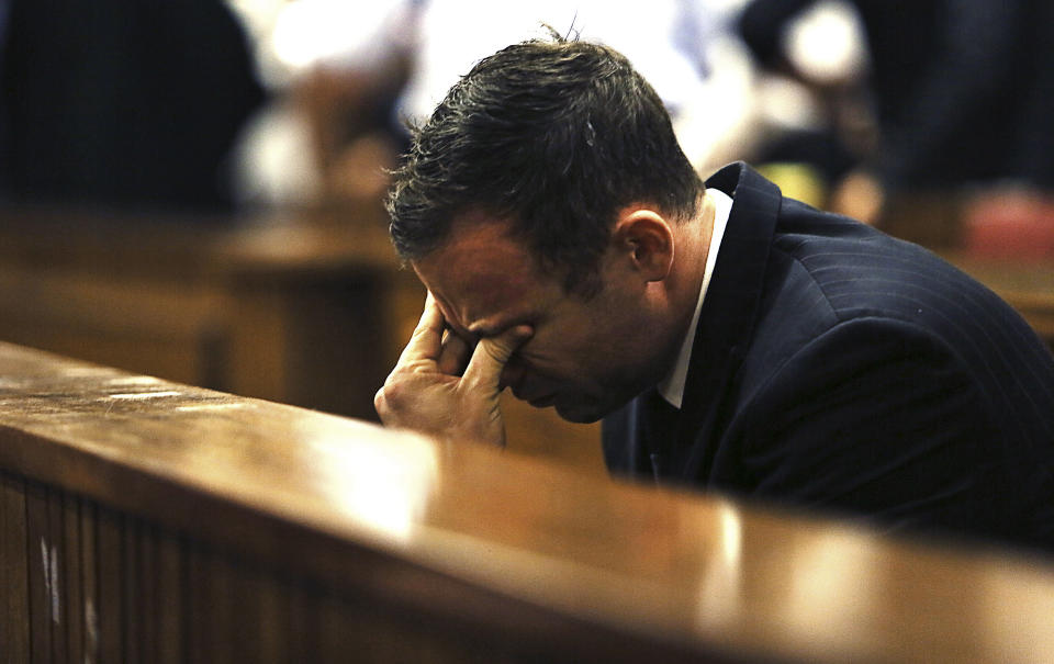  Oscar Pistorius holds his fingers to his eyes in court