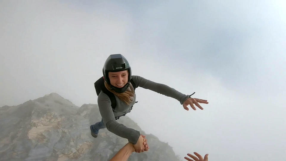 These friends filmed themselves freefalling backwards from a cliff - while holding hands. Josephine Eve, 28, and Niclas Strohmeier, 23, performed the stunt at the BASE jumping hotspot of Monte Brento, Italy. They fall backwards into the dense mist below before separating in the air and landing safely.