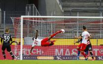 FC Cologne's Anthony Modeste shoots at goal during a German Bundesliga soccer match between 1. FC Cologne and Fortuna Duesseldorf in Cologne, Germany, Sunday, May 24, 2020. (Thilo Schmuelgen/pool via AP)