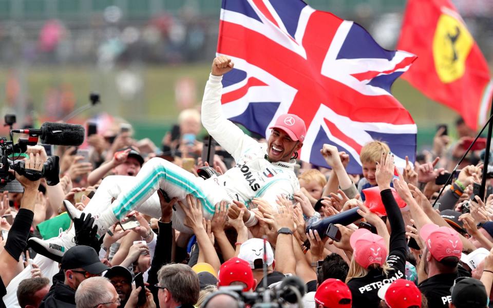 Lewis Hamilton raised aloft