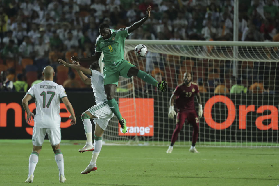 Senegal's Mbaye Hamady Niang jumps for the ball during the African Cup of Nations final soccer match between Algeria and Senegal in Cairo International stadium in Cairo, Egypt, Friday, July 19, 2019. (AP Photo/Hassan Ammar)