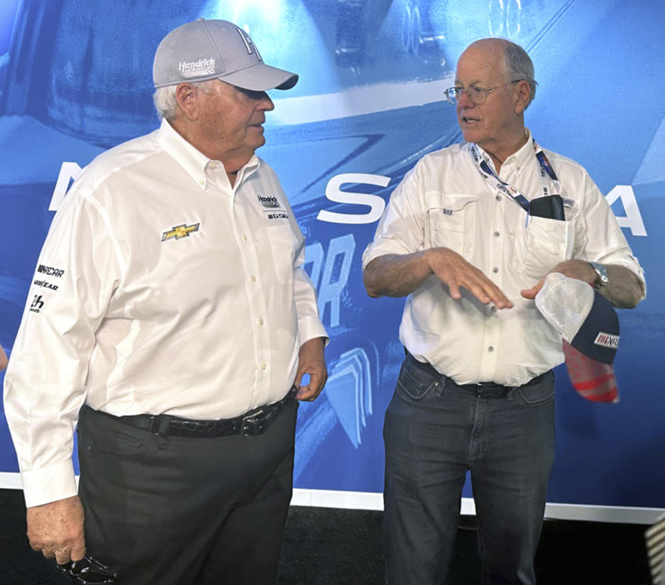 NASCAR team owner Rick Hendrick, left, and NASCAR chairman Jim France speak at the 24 Hours of Le Mans in Le Mans, France, Thursday, June 8, 2023. Hendrick Motorsports is fielding NASCAR’s entry in the prestigious sports car race. (AP Photo/Jenna Fryer)