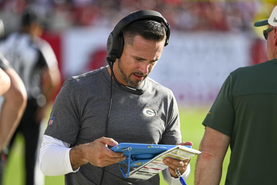 Green Bay Packers head coach Matt LaFleur looks up a play during the first half of an NFL football game against the Tampa Bay Buccaneers Sunday, Sept. 25, 2022, in Tampa, Fla. (AP Photo/Jason Behnken)