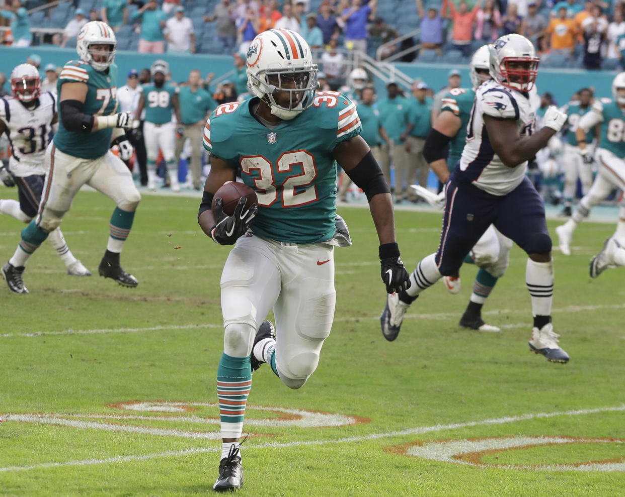 Miami Dolphins running back Kenyan Drake (32) runs for a touchdown during the second half of an NFL football game against the New England Patriots, Sunday, Dec. 9, 2018, in Miami Gardens, Fla. The Dolphins defeated the Patriots 34-33. (AP Photo/Lynne Sladky)