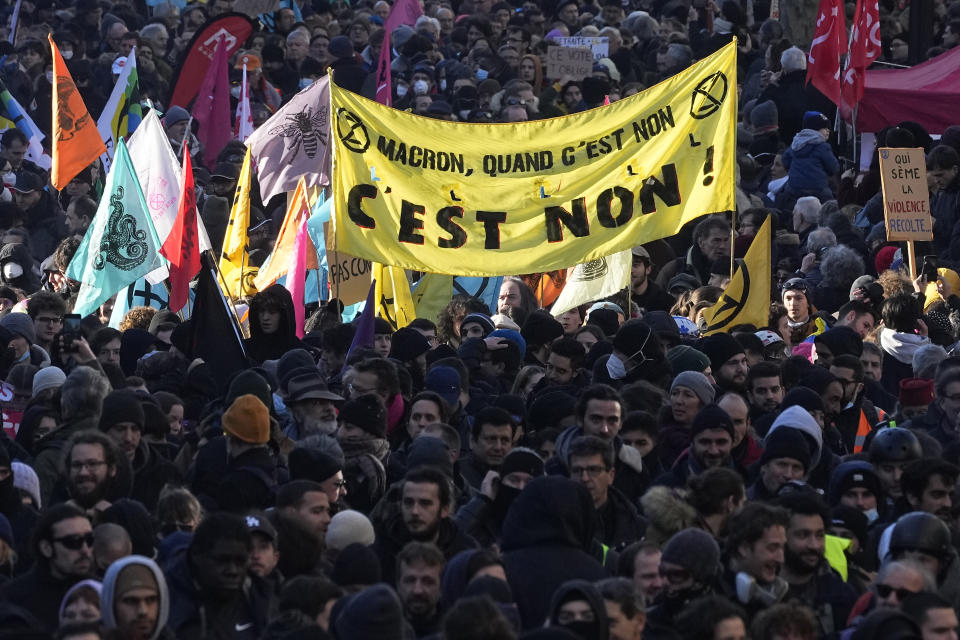 Protesters march with a banner reading "Macron when it's a No, it's a No" during a demonstration against plans to push back France's retirement age, Tuesday, Feb. 7, 2023 in Paris. The demonstration comes a day after French lawmakers began debating a pension bill that would raise the minimum retirement from 62 to 64. The bill is the flagship legislation of President Emmanuel Macron's second term. (AP Photo/Michel Euler)