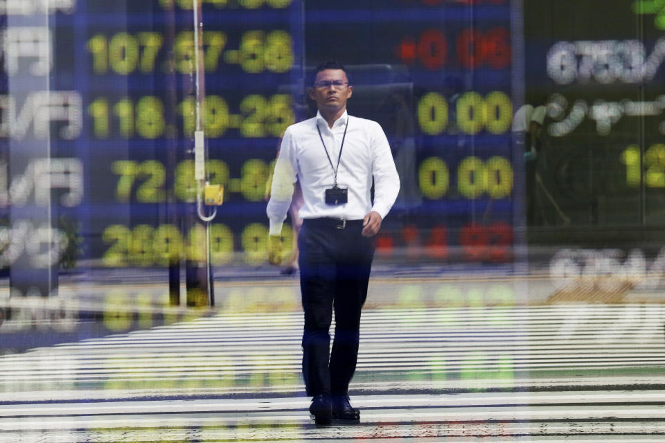 A man is reflected on the electronic board of a securities firm in Tokyo, Tuesday, Sept 24, 2019. Shares have edged higher in Asia as U.S. Treasury Secretary Steven Mnuchin confirmed that China-U.S. trade talks were due to resume in two weeks’ time. The Shanghai Composite index rose 0.8% and shares also rose in Tokyo and Hong Kong. (AP Photo/Koji Sasahara)