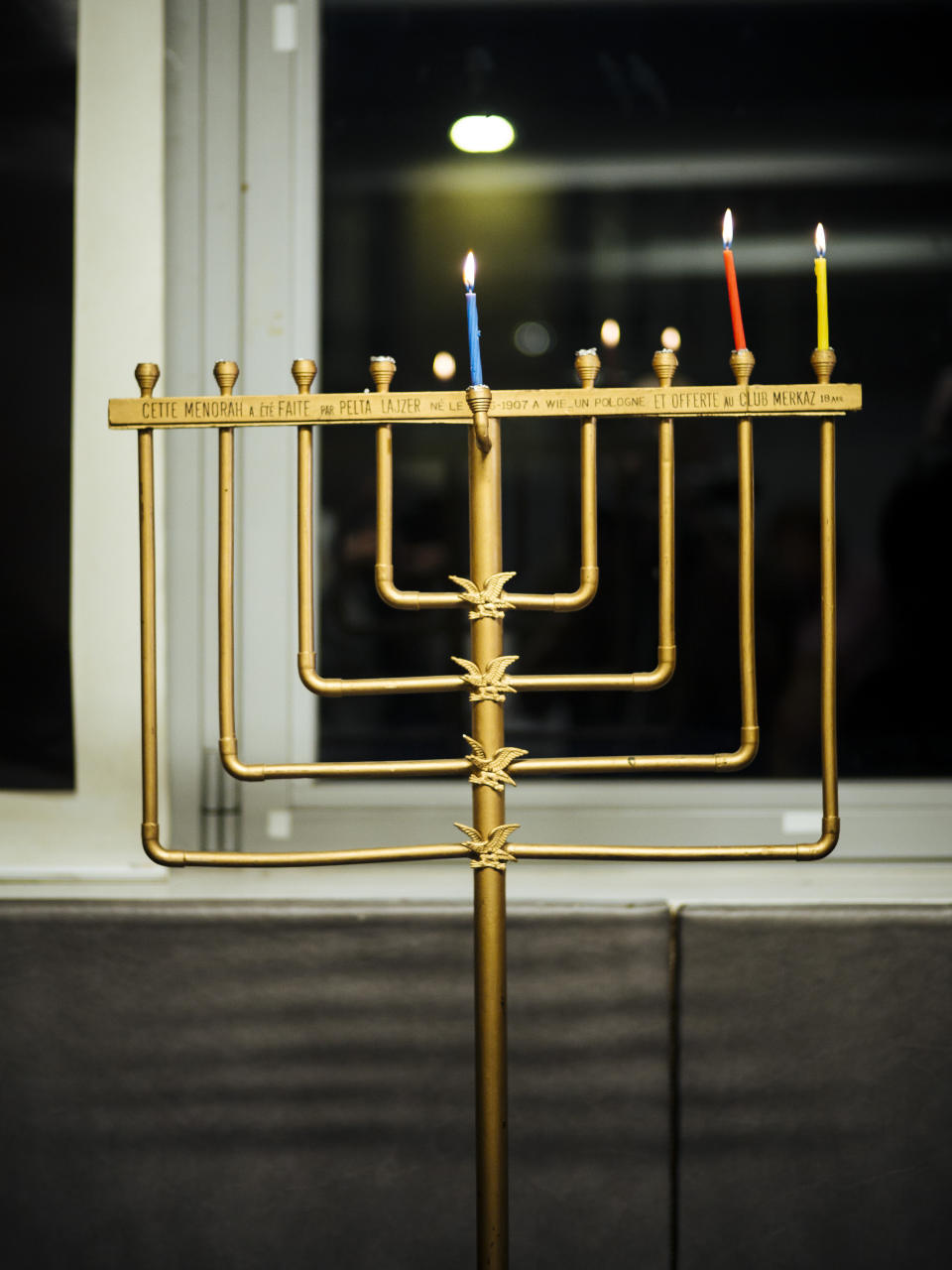 A menorah is seen during an event named 'Survivors Night' in Paris, Monday, Dec. 23, 2019. Holocaust survivors in several cities around the world are lighting candles for Hanukkah together, as Jewish community leaders try to keep first-hand memories of the Nazi horrors alive. The events were organized by the Conference on Jewish Material Claims Against Germany. (AP Photo/Kamil Zihnioglu)