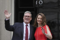 Britain's Labour Party Prime Minister Keir Starmer and his wife Victoria wave to the crowds of supporters and media from the doorstep of 10 Downing Street in London, Friday, July 5, 2024. Labour leader Starmer won the general election on July 4, and was appointed Prime Minster by King Charles III at Buckingham Palace, after the party won a landslide victory. (AP Photo/Kin Cheung)