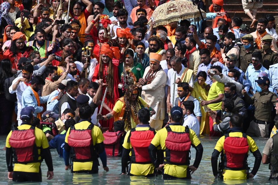 Followers of the Kinnar Akhara monastic Hindu order made up of transgender members take a holy dip in the waters of the River Ganges on the Shahi snan (grand bath) on the occasion of Maha Shivratri festival during the ongoing religious Kumbh Mela festival in Haridwar on March 11, 2021. (Photo by Prakash SINGH / AFP) (Photo by PRAKASH SINGH/AFP via Getty Images)