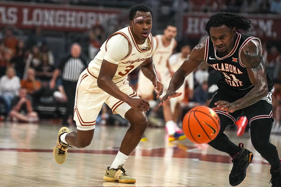 Texas guard Max Abmas and Oklahoma State guard John-Michael Wright battle for a loose ball during the Longhorns' 81-65 win Saturday at Moody Center. UT used a 14-0 spurt midway through the second half to pull away.