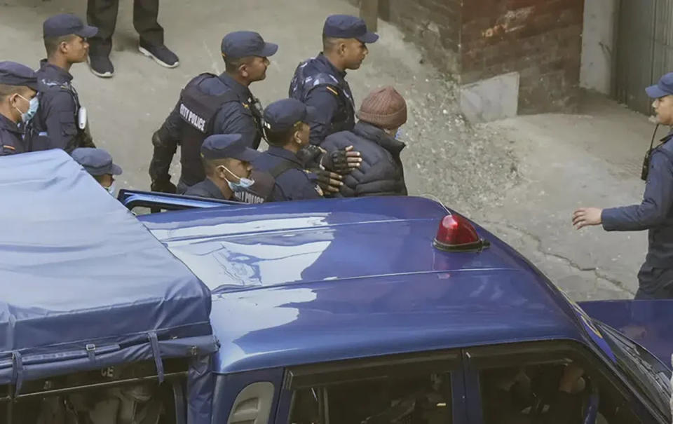Nepalese police escort Charles Sobhraj, in brown cap, to the immigration office, in Kathmandu, Nepal, Friday, (AP)