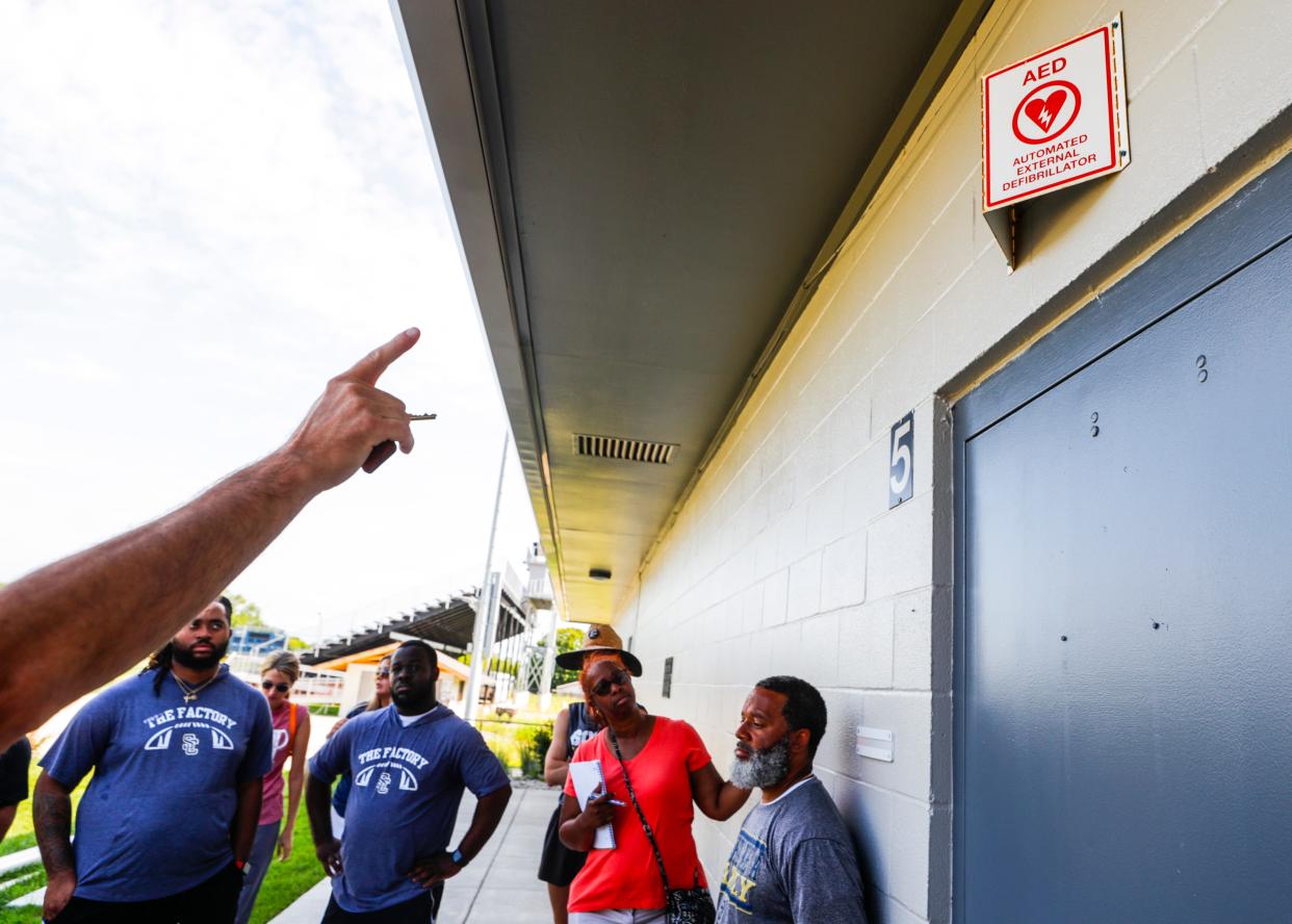 A trainer makes note of the room where an automated external defibrillator (AED) is stored at the Shelby County High School football stadium during a training session with coaches on July 20, 2023.