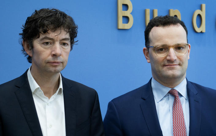Christian Drosten, left, virologist of the Charite hospital, and German Health Minister Jens Spahn, right, arrive for a press conference on the new coronavirus in Berlin, Germany, Monday, March 9, 2020. (AP Photo/Michael Sohn)