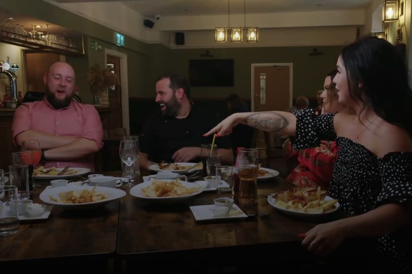 Four people sat at a table