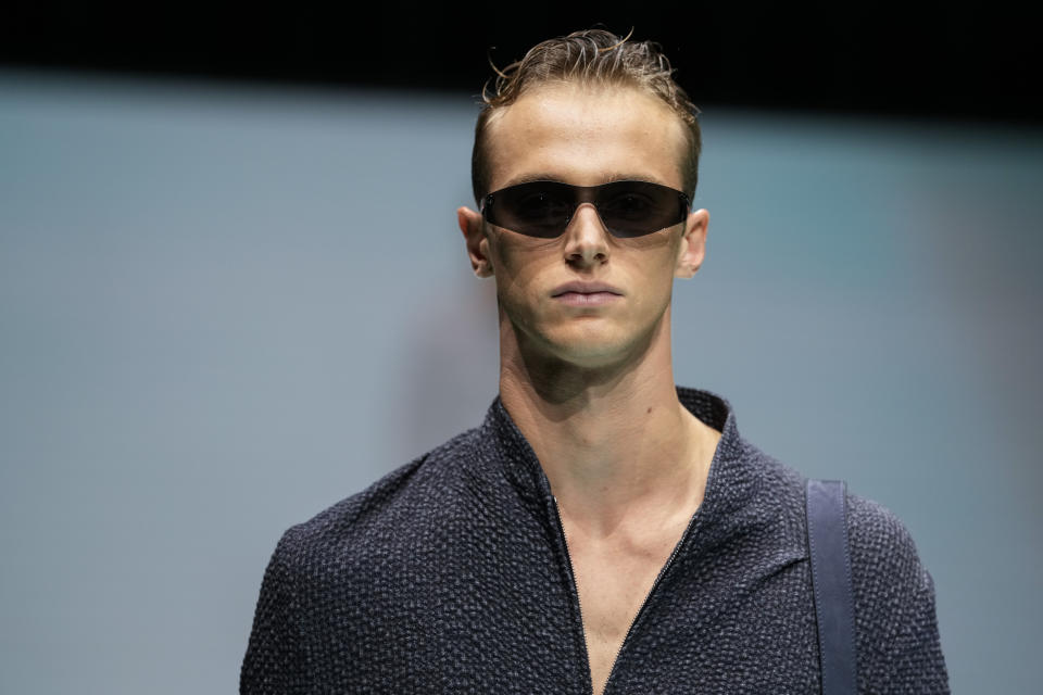 FILE - A model wears a creation for the Emporio Armani Spring Summer 2022 collection during Milan Fashion Week, in Milan, Italy, Thursday, Sept. 23, 2021. Milan menswear previews for fall/winter 2021-22 are returning to a mostly in-person format in January, with Zegna, Giorgio Armani, Fendi and Prada among the 22 brands staging live runway shows, Milan’s fashion council announced Monday, Dec. 13, 2021. (AP Photo/Luca Bruno, File)