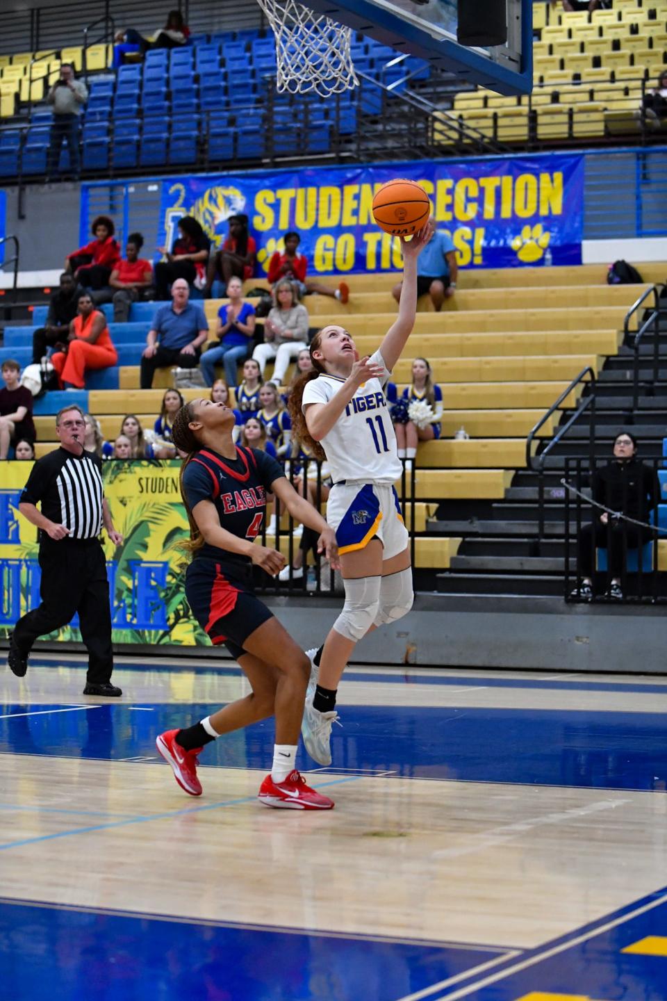 Martin County's Karolina Ramirez (11) drives to the basket against Centennial's Jada Parson (4) in a girls high school basketball game, Tuesday, Jan. 23, 2024.