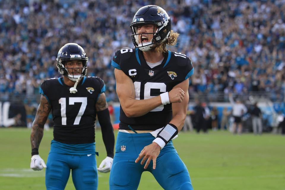 Jaguars quarterback Trevor Lawrence (16) reacts to a touchdown pass as tight end Evan Engram (17) looks on.