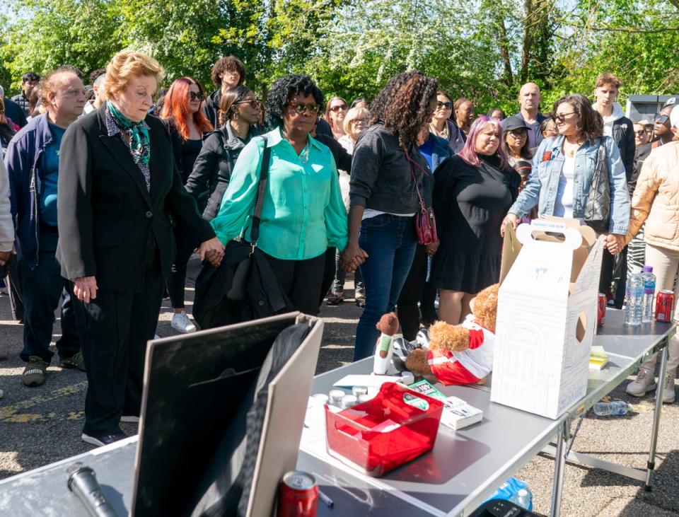 People attend the vigil at Hainault Underground Station Car Park (PA Wire)