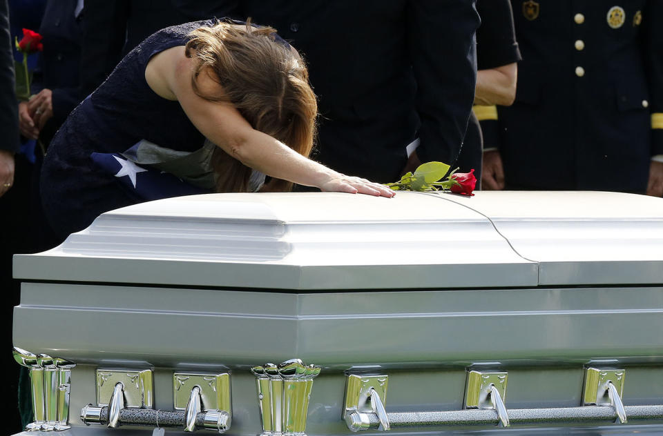 <p>Susan Myers, wife of U.S. Army Maj. Gen. Harold J. Greene, pats his casket during the end of a full military honors funeral at Arlington National Cemetery in Virginia, Aug. 14, 2014. Greene was killed in Afghanistan earlier this month and is the highest ranking U.S. military officer killed in combat since the Vietnam War. (Photo: Larry Downing/Reuters) </p>