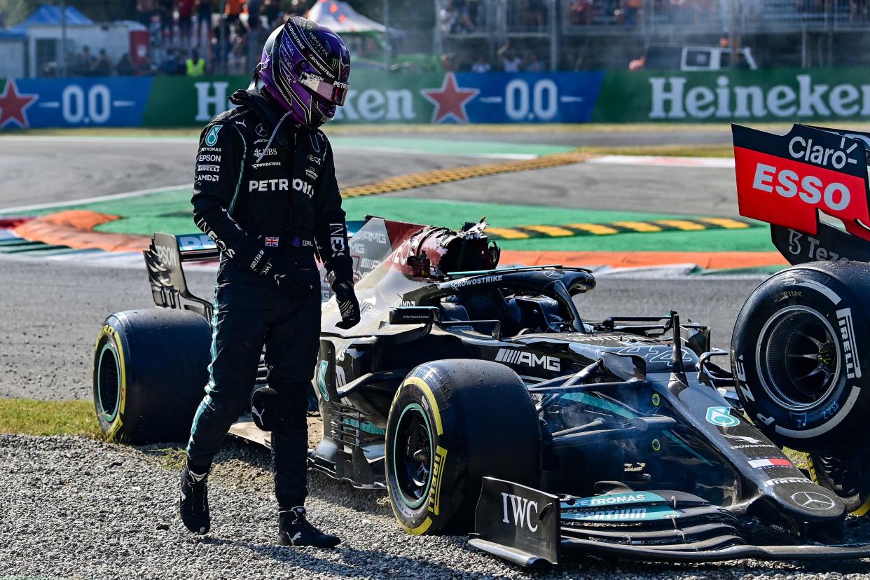 Lewis Hamilton gets out of his car following a collision with Max Verstappen.