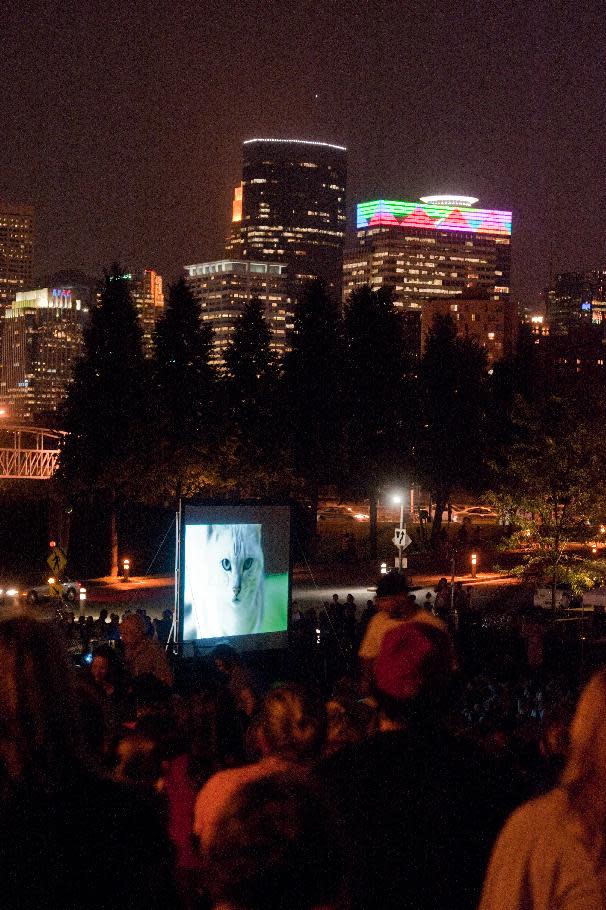 The Minneapolis skyline is the backdrop for The Walker Art Center for the first "Internet Cat Video Film Festival," showcasing the best of cat films on the Internet in Minneapolis Thursday, Aug. 30, 2012. The Walker Art Center in Minneapolis held its first-ever online cat video festival, a compilation of silly cat clips that have become an Internet phenomenon, attracting millions of viewers for some of the videos. (AP Photo/Craig Lassig)