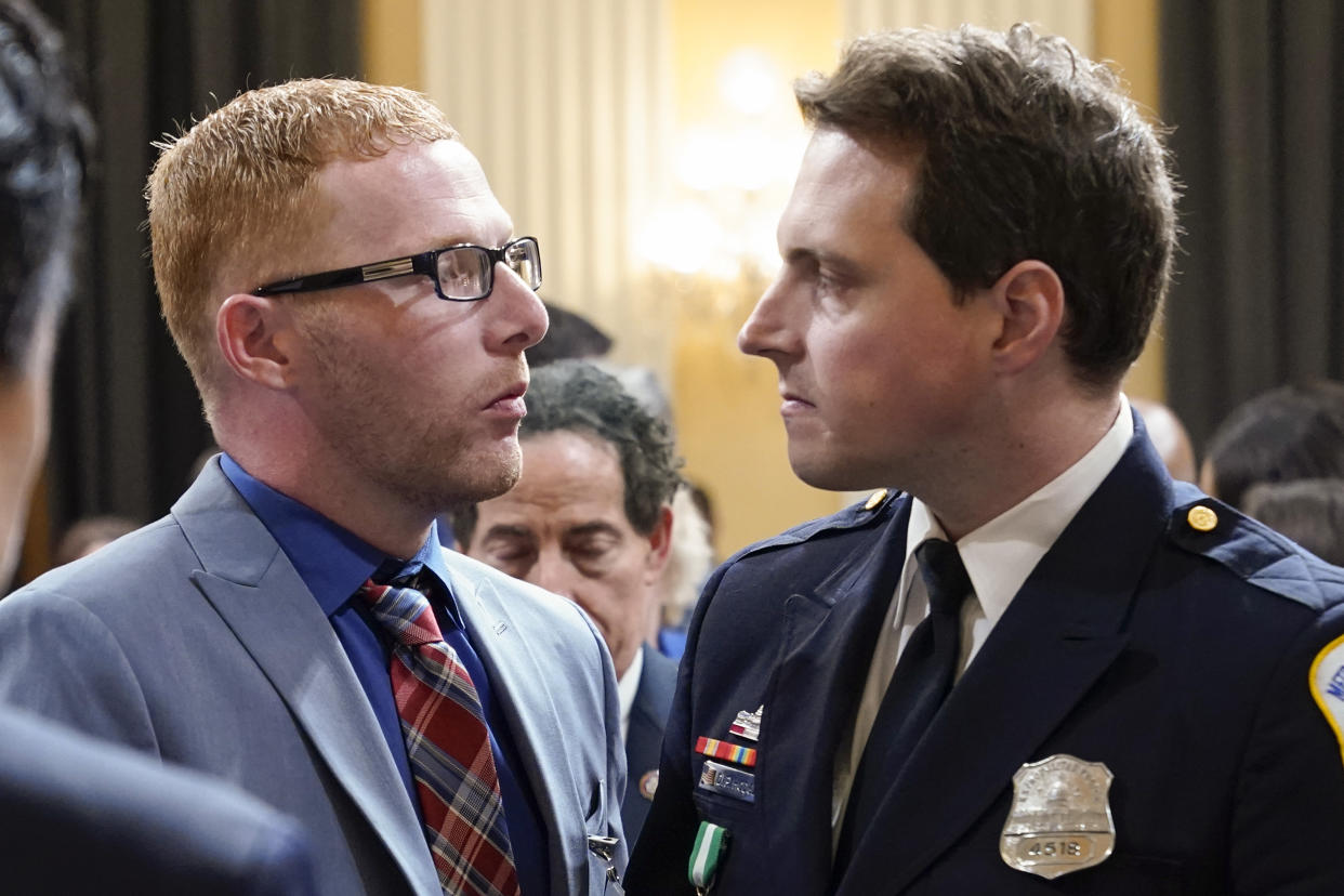 FILE - Stephen Ayres, who pleaded guilty last in June 2022 to disorderly and disruptive conduct in a restricted building, shakes hands with Washington Metropolitan Police Department officer Daniel Hodges as the hearing with House select committee investigating the Jan. 6 attack on the U.S. Capitol ends at the Capitol in Washington, July 12, 2022. Ayers has been sentenced to two years of probation for his role in the mob’s attack. U.S. District Judge John Bates also on Thursday ordered 41-year-old Stephen Ayres to perform 100 hours of community service. Prosecutors had recommended sentencing Ayres to 60 days of incarceration. (AP Photo/Jacquelyn Martin, File)