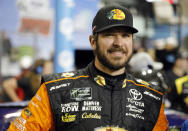 Martin Truex Jr. stands next to his car during qualifying for the NASCAR Cup Series auto race at the Homestead-Miami Speedway, Friday, Nov. 16, 2018, in Homestead, Fla. (AP Photo/Terry Renna)