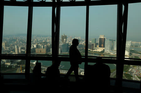 A visitor walks inside Macau Tower overlooking the skyline of Macau peninsula, China October 8, 2015. Picture taken October 8, 2015. REUTERS/Bobby Yip