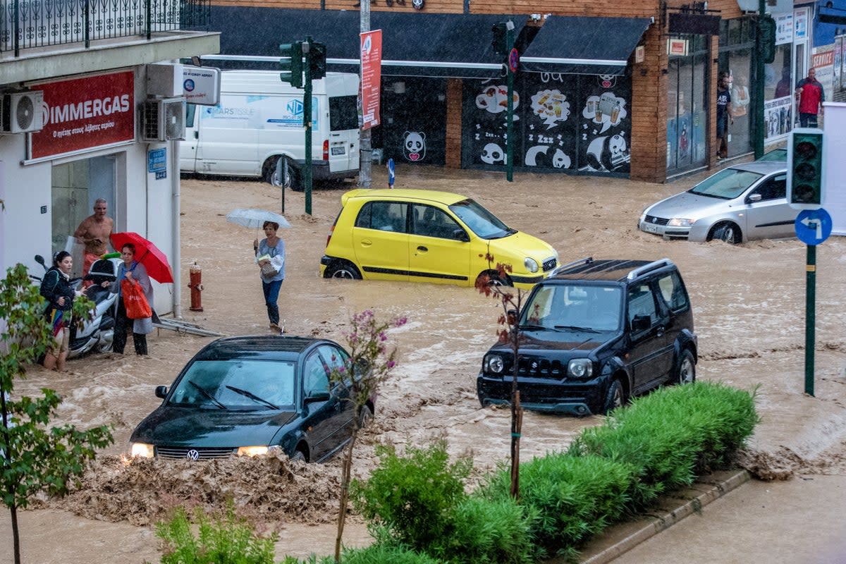 Cars drive in rising waters following a flash flood during a storm in the city of Volos, Greece, on September 5 (Anastasia Karekla / Eurokinissi / Reuters)